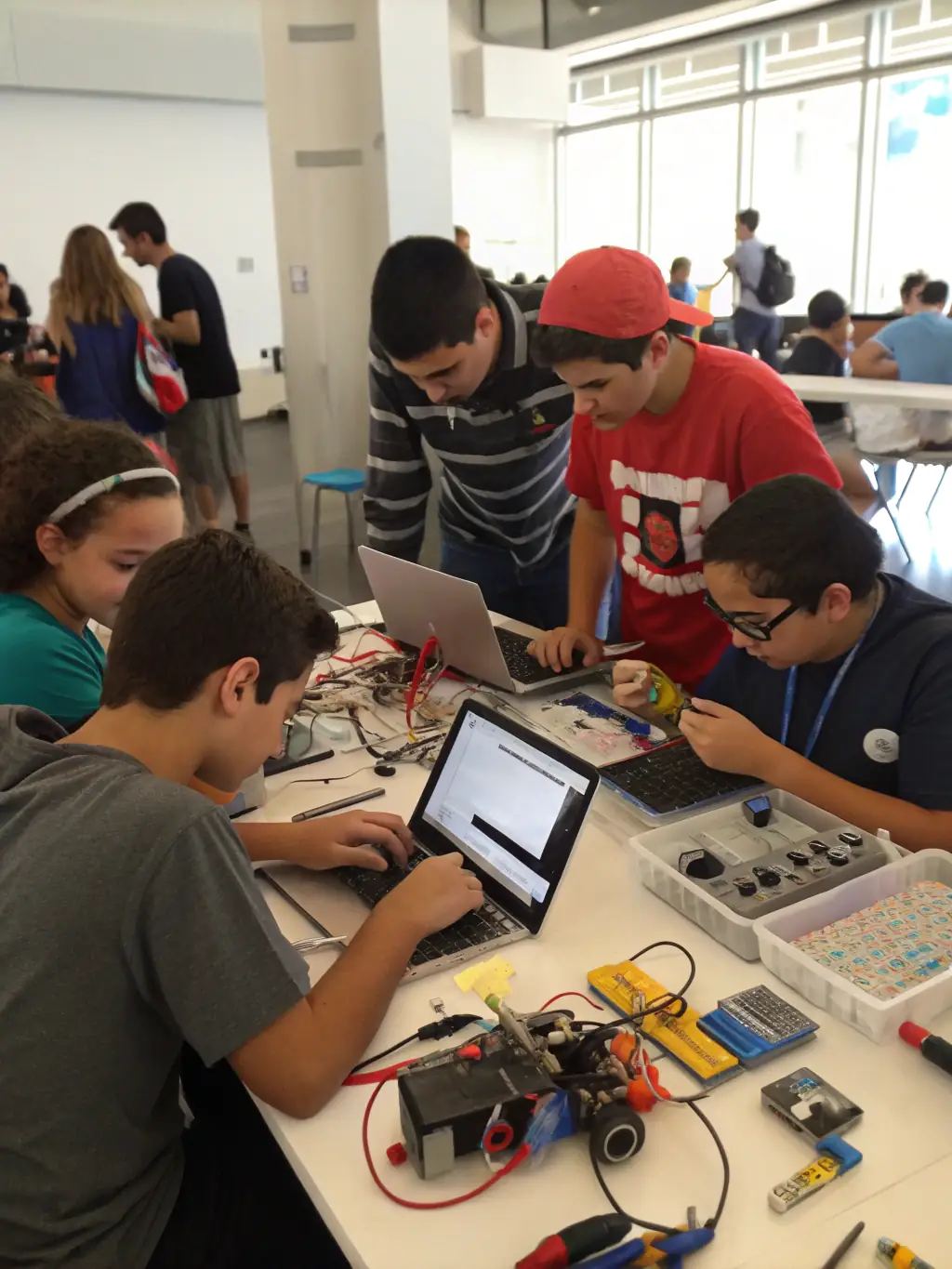 A group of students collaborating on a robotics project, demonstrating teamwork and the application of engineering principles. The setting should be a modern, well-equipped classroom.